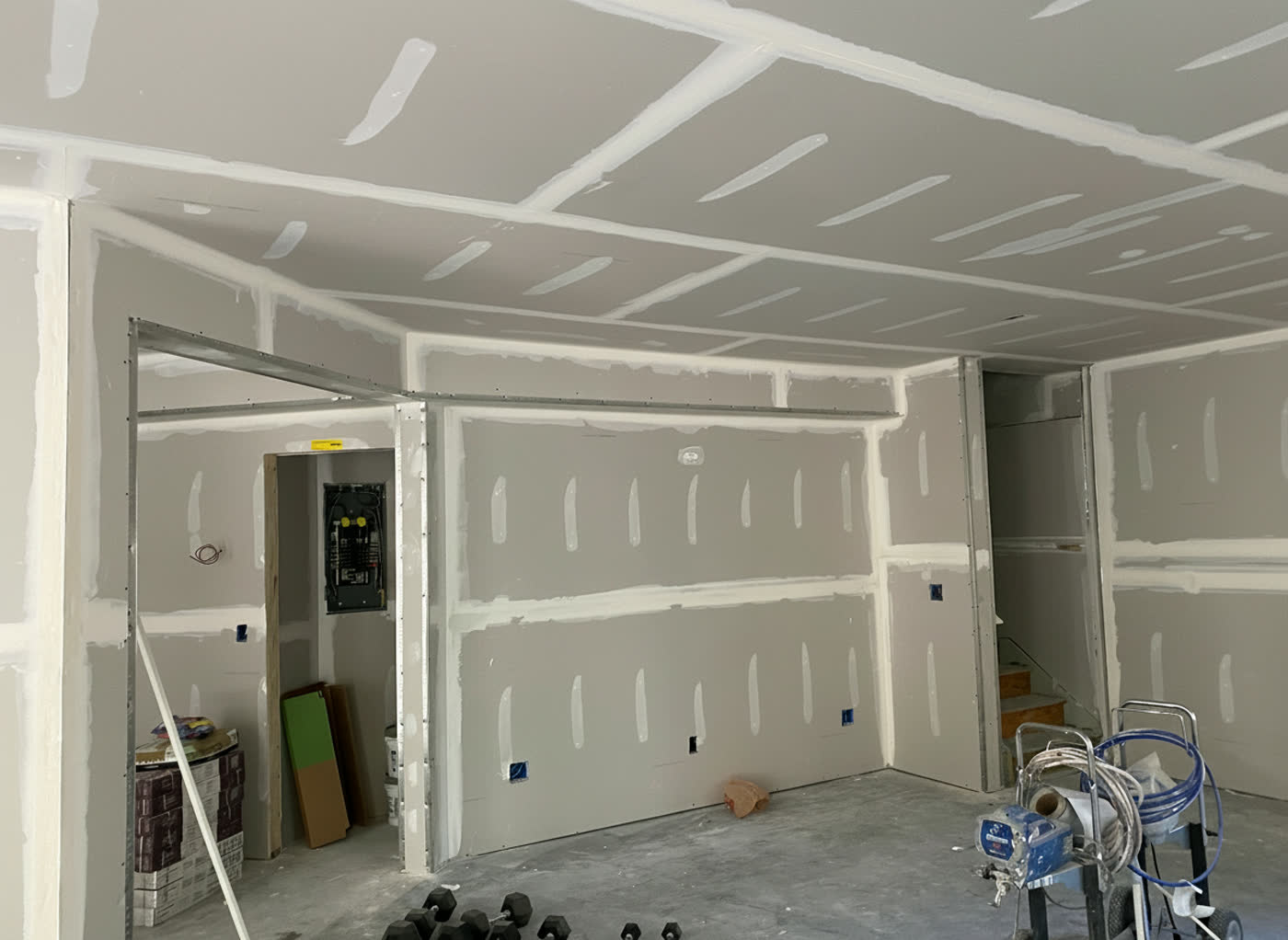 Basement drywall hung, taped and mudded, ready for finishing
