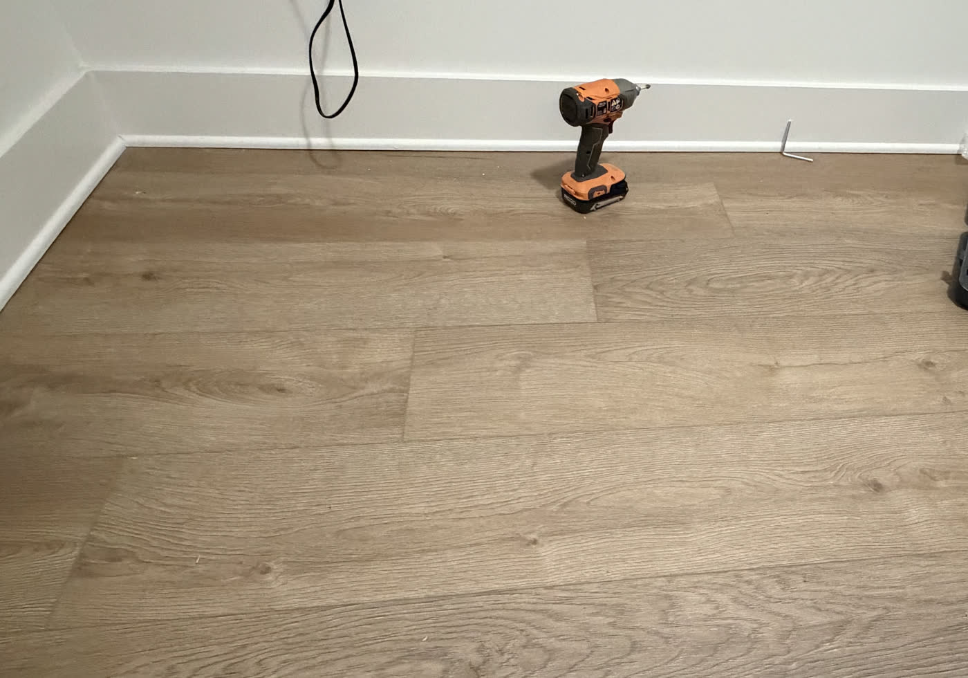 Luxury vinyl plank flooring laid and trimmed out to the baseboard