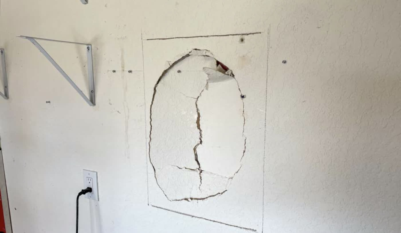 Damaged section cut back to a square, pencil layout lines marking the patch